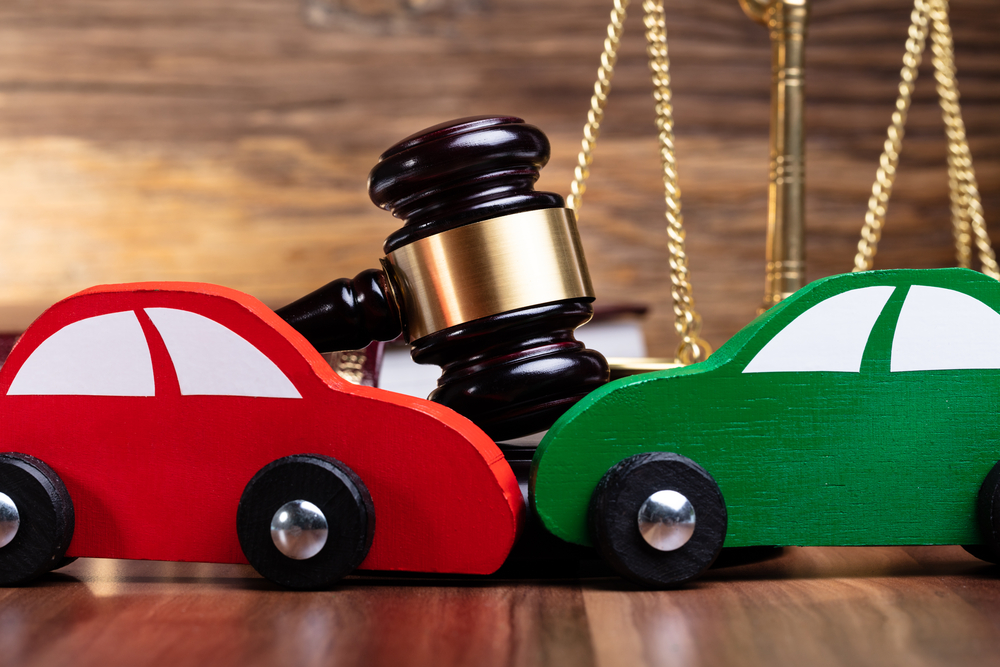 Burbank Car Accident Lawyers - Close-up Of Two Green And Red Wooden Cars On Desk In Courtroom