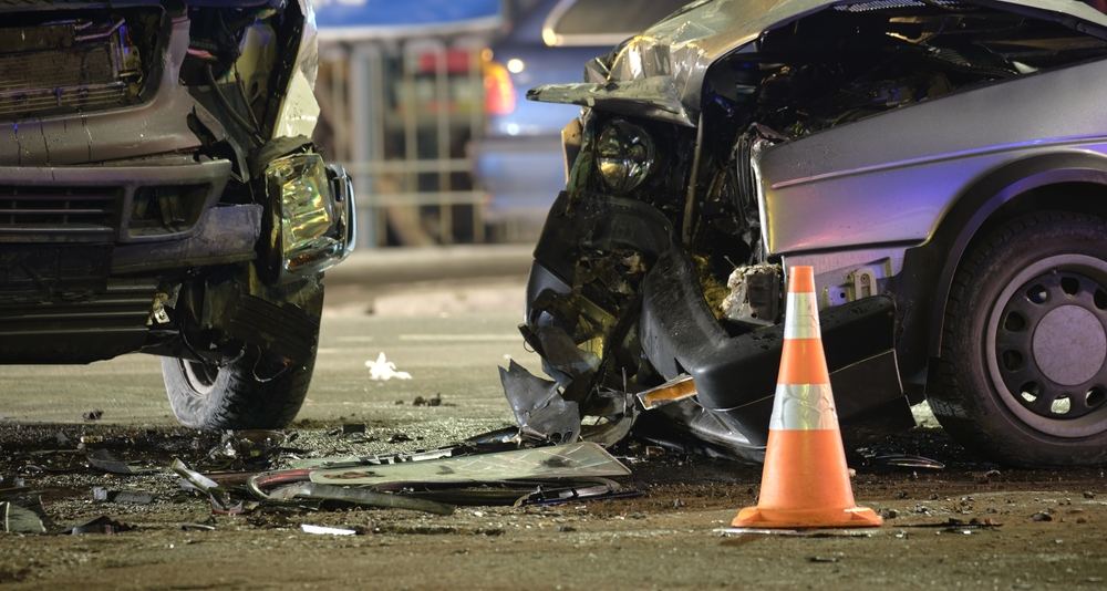 Wreckage from a nighttime head-on car collision
