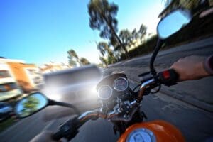 First-person view of motorcycle handlebars in Los Angeles traffic