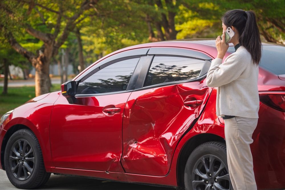 Woman calling Anaheim car accident lawyer after side-impact collision damage