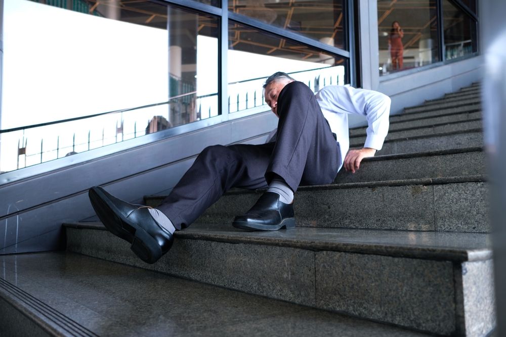 Person injured after a slip and fall accident on unsafe stairs in Anaheim commercial property