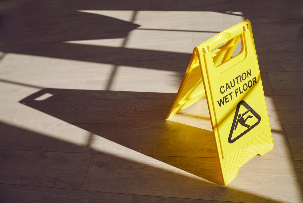 Wet floor warning sign at a commercial property where a slip and fall accident could occur in Anaheim