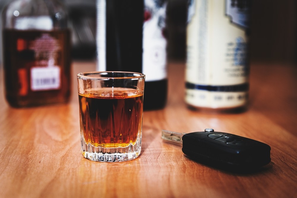 Shot glass and car keys on a table, representing drunk driving risks in Los Angeles