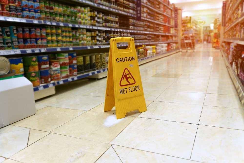 Wet floor caution sign in a Los Angeles grocery store aisle