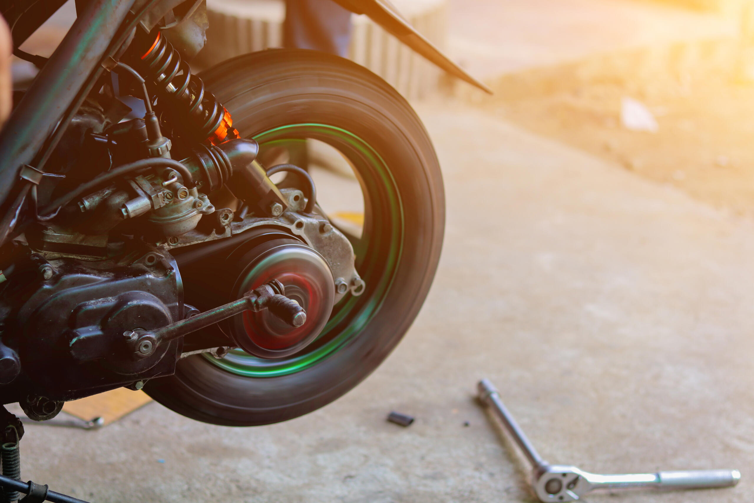 Close up view of a motorcycle wheel and frame illustrating mechanical and crash damage reviewed by Burbank motorcycle accident lawyers.