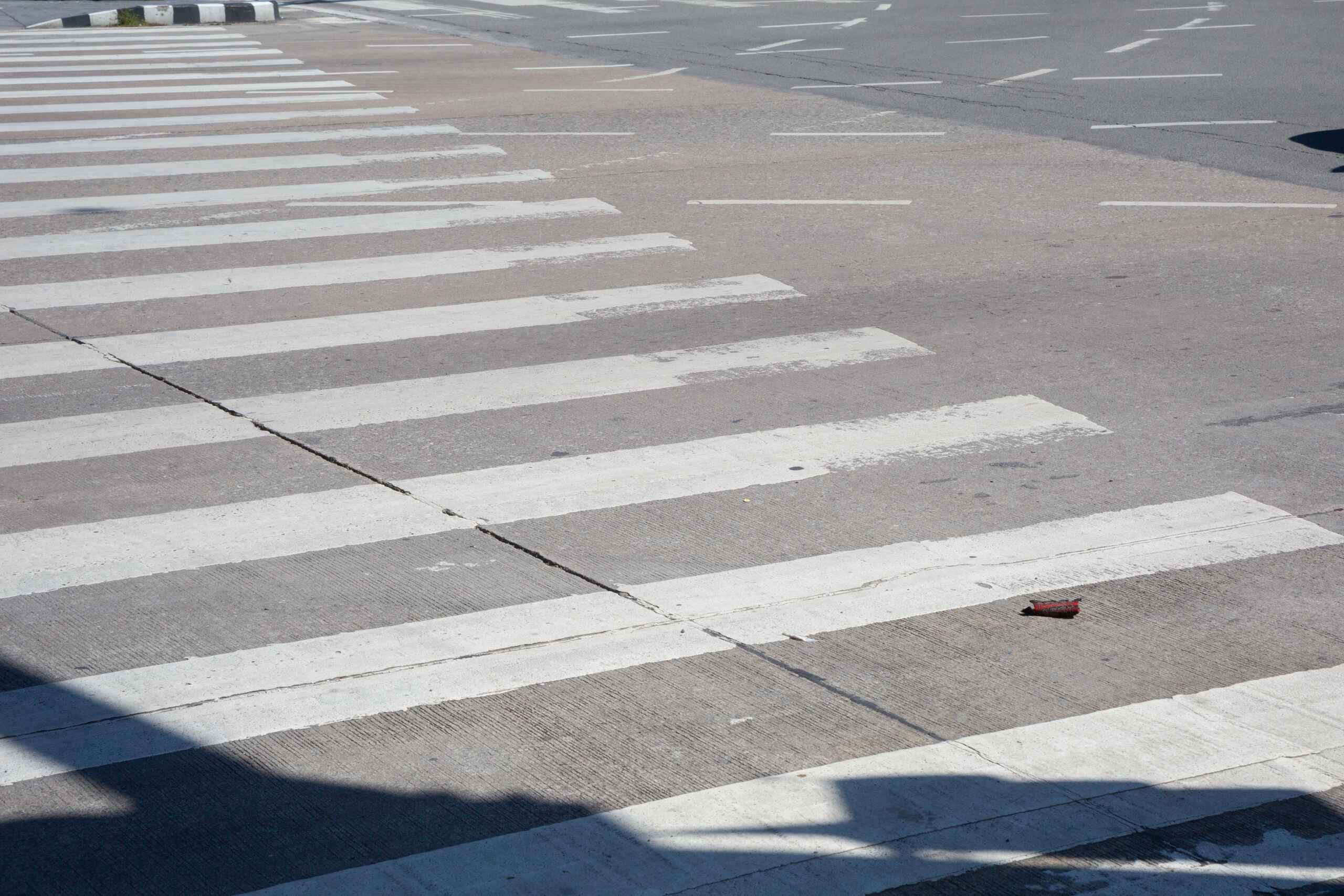 Empty street crosswalk where hit pedestrians consult Burbank pedestrian accident lawyers.