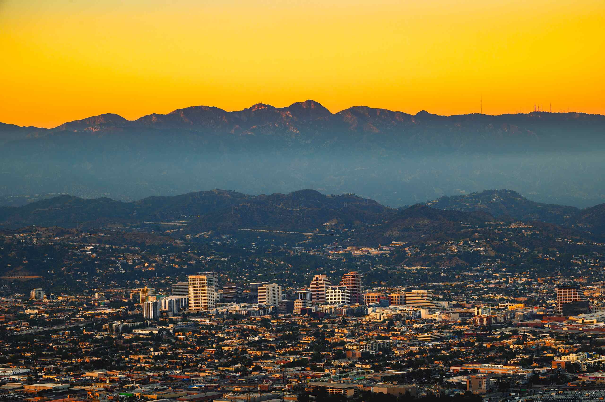 Aerial sunset view of Los Angeles and surrounding mountains where riders must follow rules explained in the California motorcycle helmet laws complete guide.