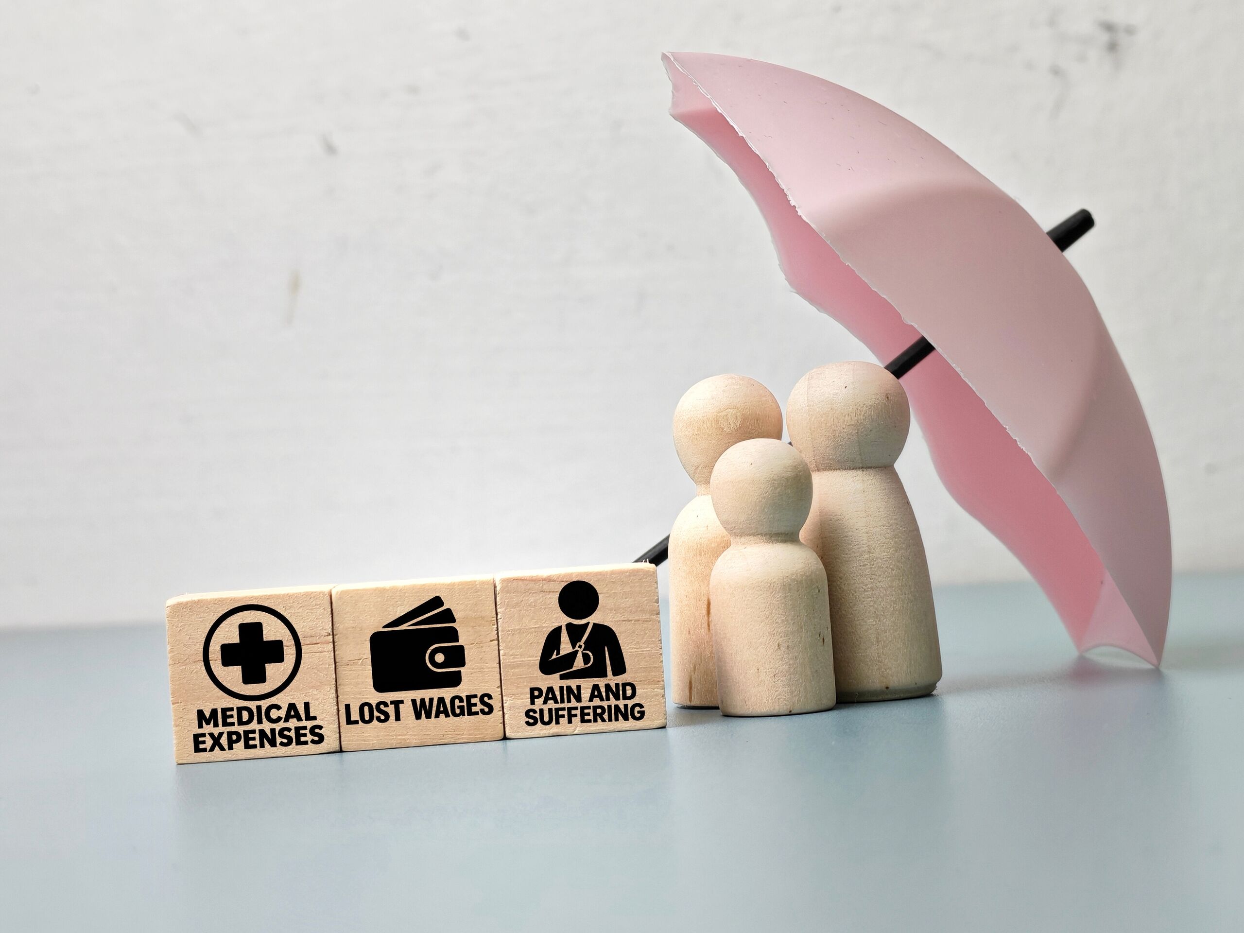 Wooden blocks displaying medical expenses and lost wages explain how damages are calculated in a California personal injury case.