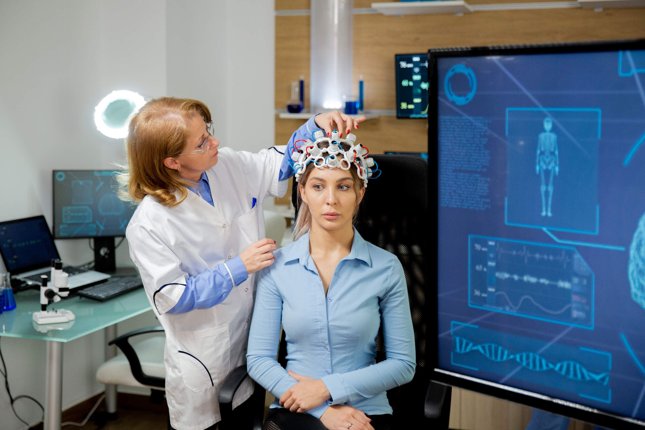 A medical specialist attaching EEG brain sensors to a patient reviewed by Los Angeles brain injury attorneys.