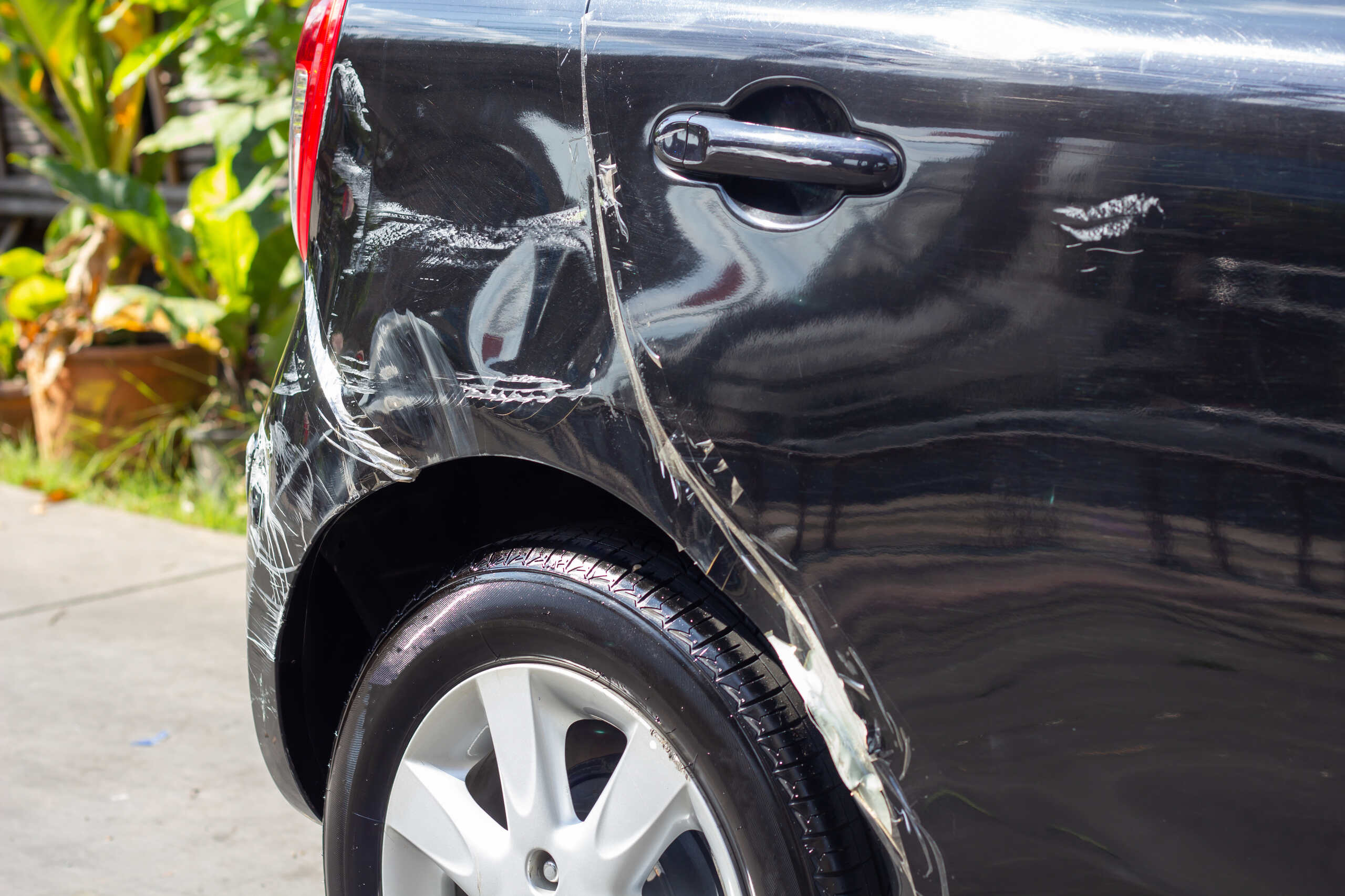 A black car shows side damage from a crash handled by Los Angeles hit and run attorneys.