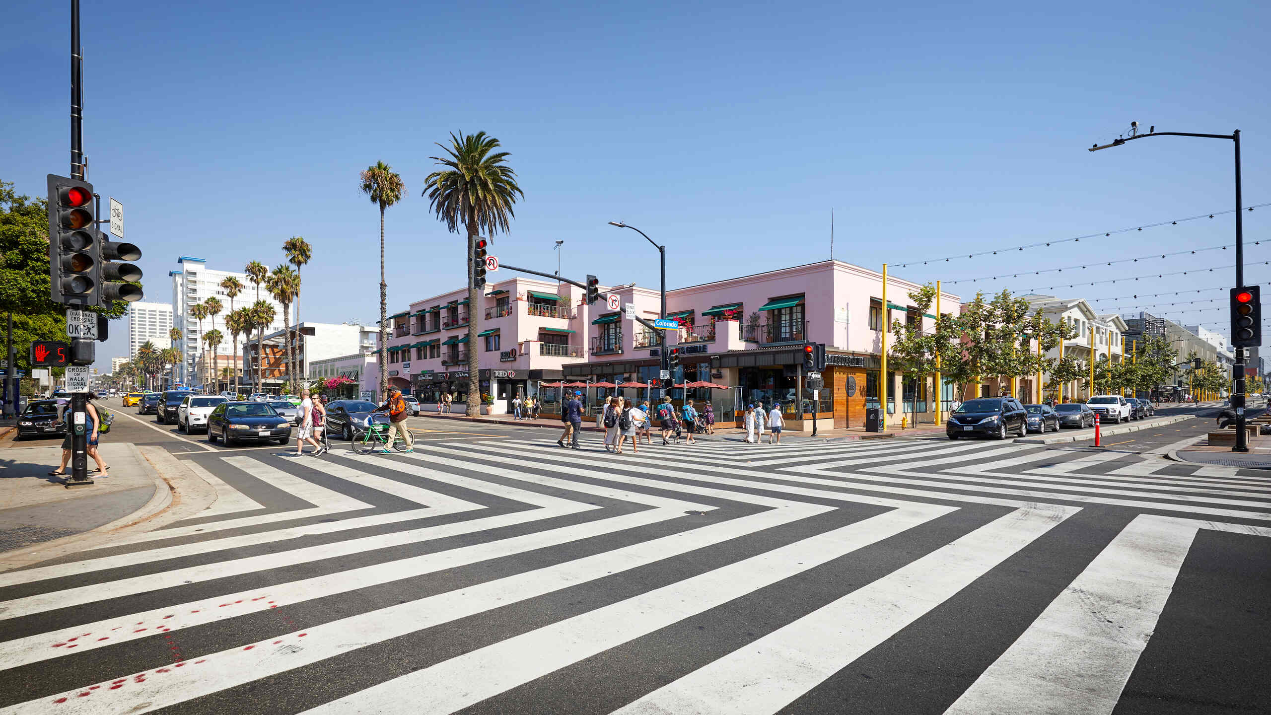 Pedestrians walking across a marked crosswalk at a busy intersection representing cases handled by Los Angeles pedestrian accident attorneys.
