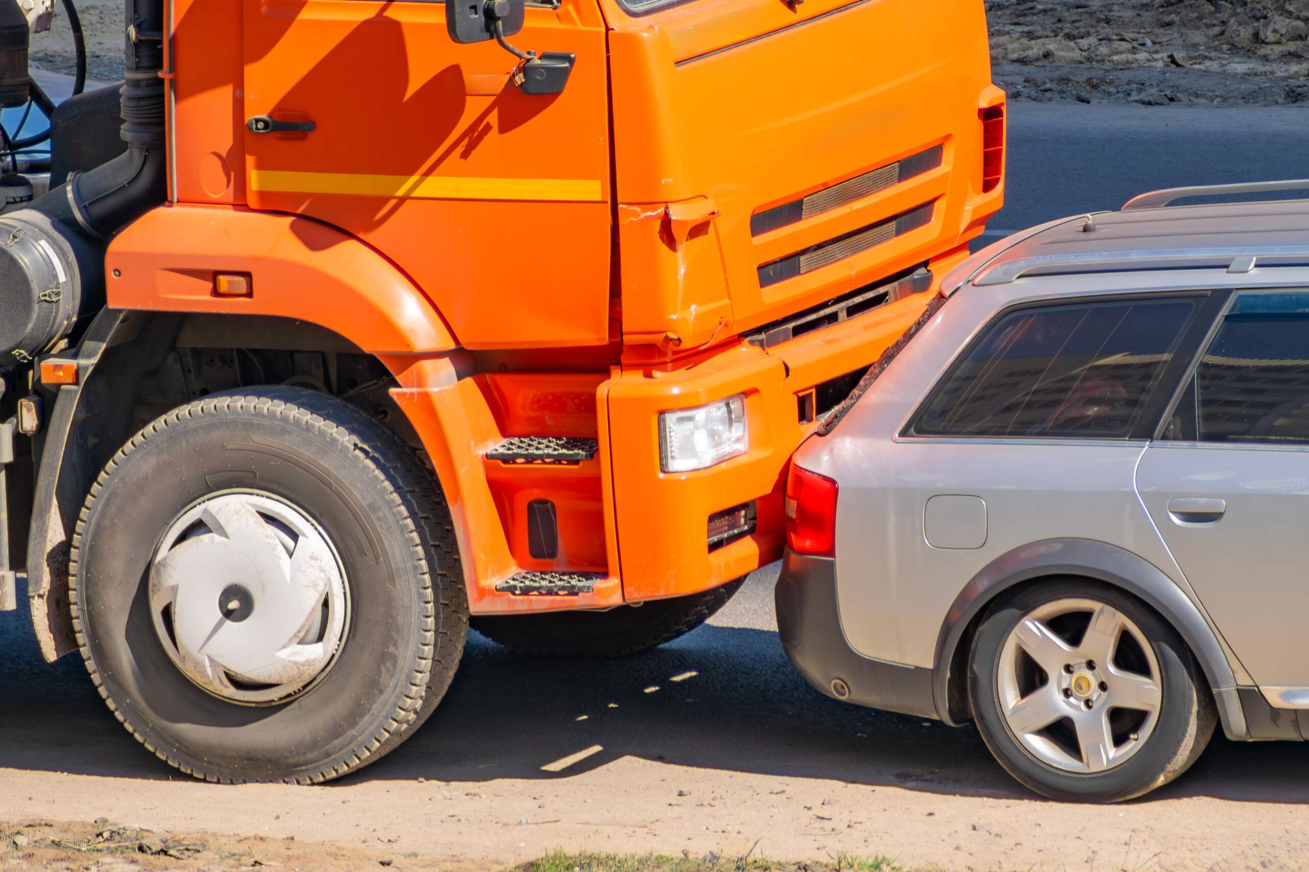 An orange truck crashes into the rear of a passenger car in a collision investigated by Anaheim truck accident lawyers.